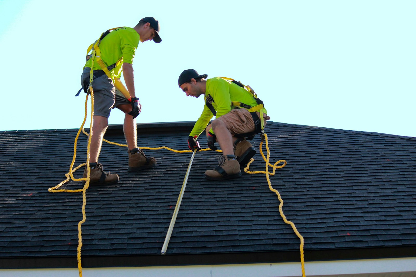 Roofer assessing under a heavy sky